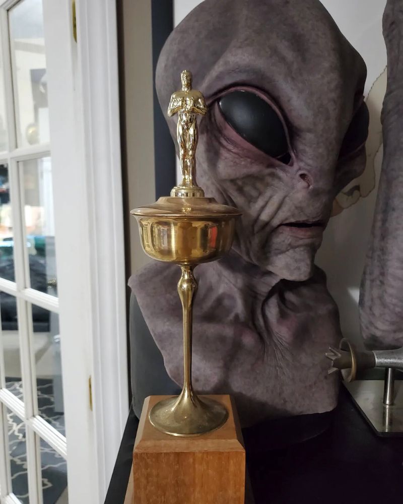 Alien Area 51 mask on display with a vintage trophy in a collector’s room from The Terror Lab.