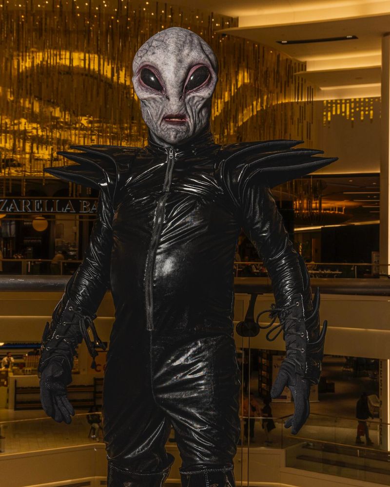 Alien Area 51 mask spotted at mall — Dressed in full black sci-fi armor, captured during Halloween night appearance. The Terror Lab.
