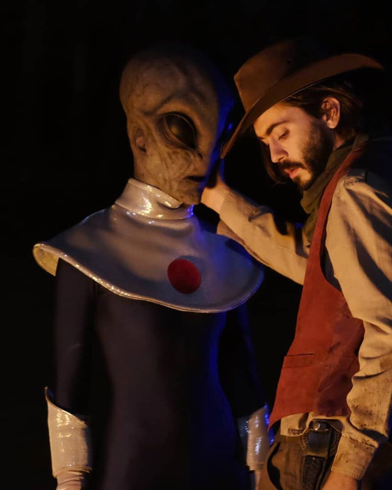 Alien mask in full costume during cinematic western scene at night – The Terror Lab.