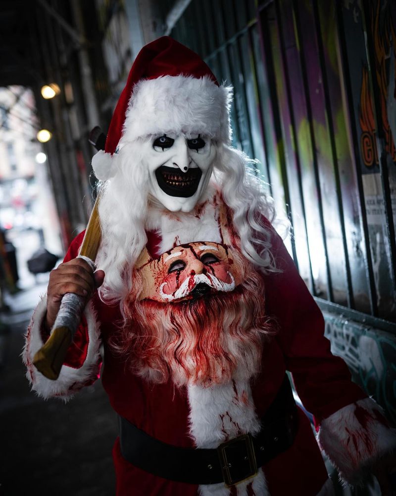 Wearing the Art the Clown realistic mask with a Santa costume and bloody chest print during a Halloween night — The Terror Lab.