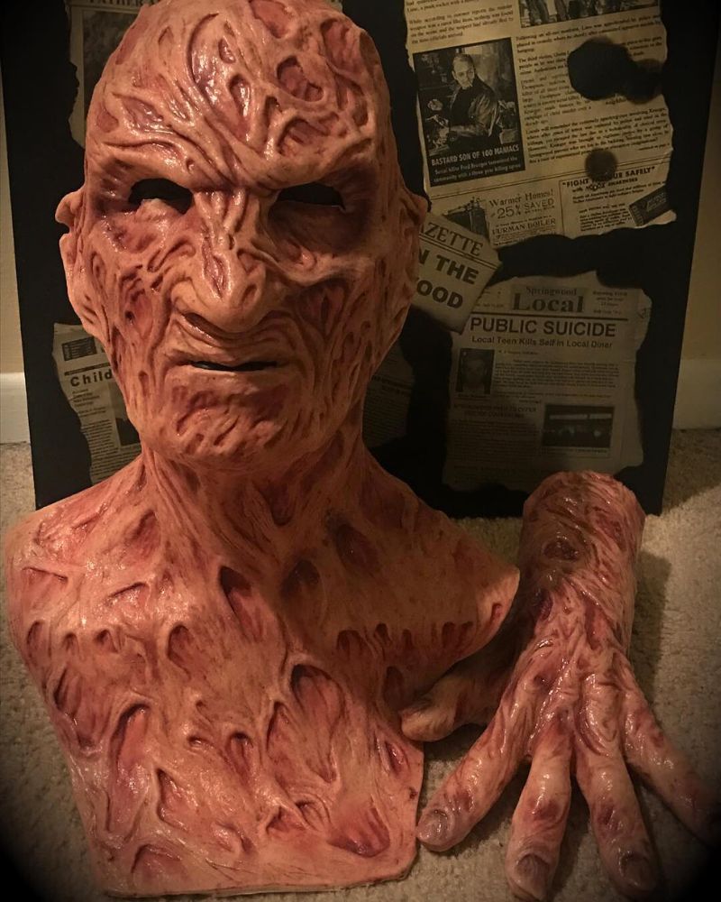 Freddy Krueger mask and burnt hand displayed against a backdrop of twisted newspaper clippings, perfect for horror fans and collectors – The Terror Lab