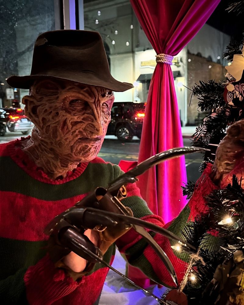 Freddy Krueger sneaking around a Christmas tree in full costume and claws — the ultimate horror-cosplay twist spotted during the holidays from The Terror Lab.