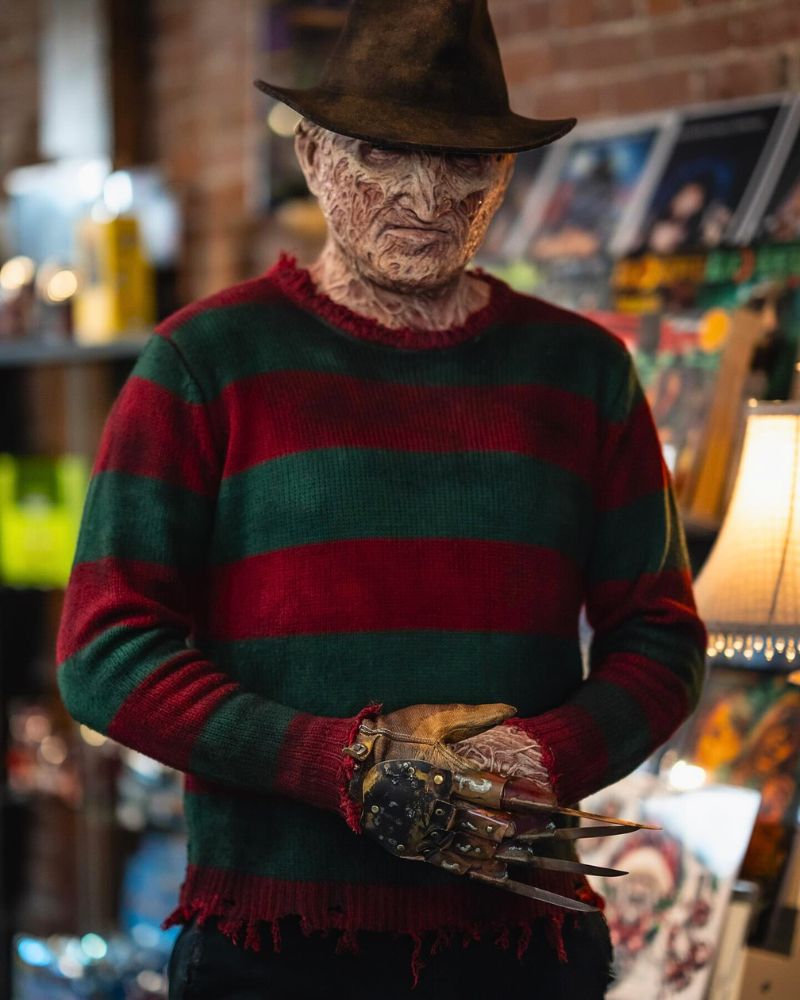Full Freddy Krueger cosplay spotted at a horror-themed comic shop — mask, glove, and sweater all on point from The Terror Lab.
