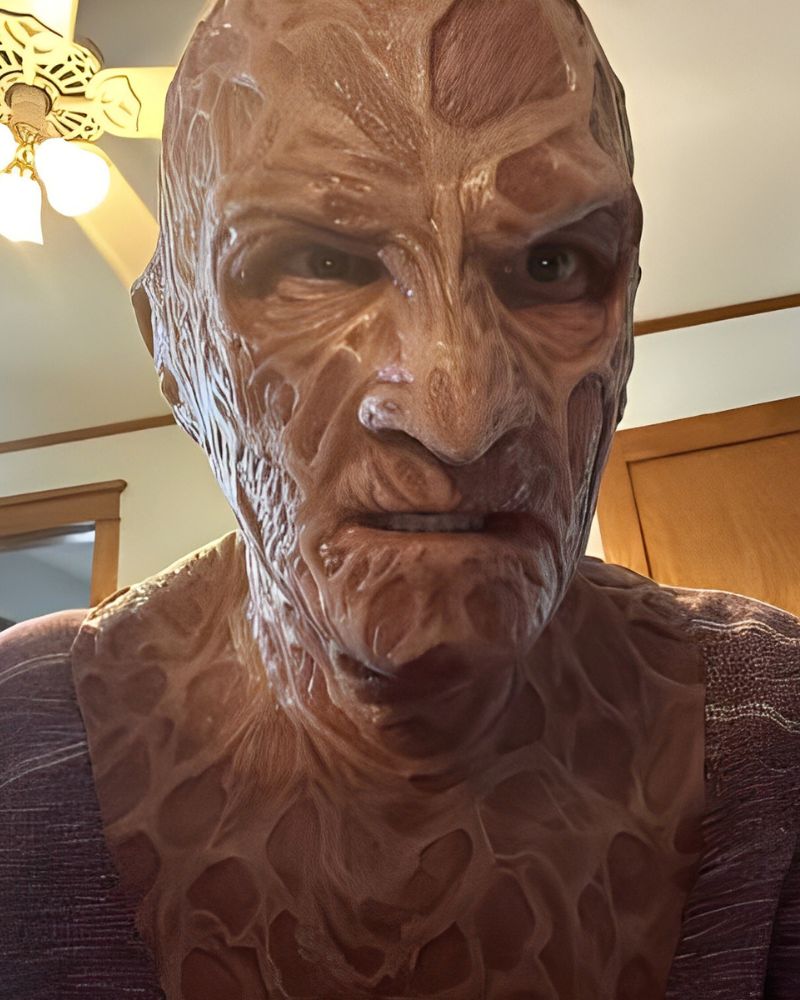 A customer wearing the Freddy Krueger mask at home, captured in character before heading to a Halloween party – The Terror Lab