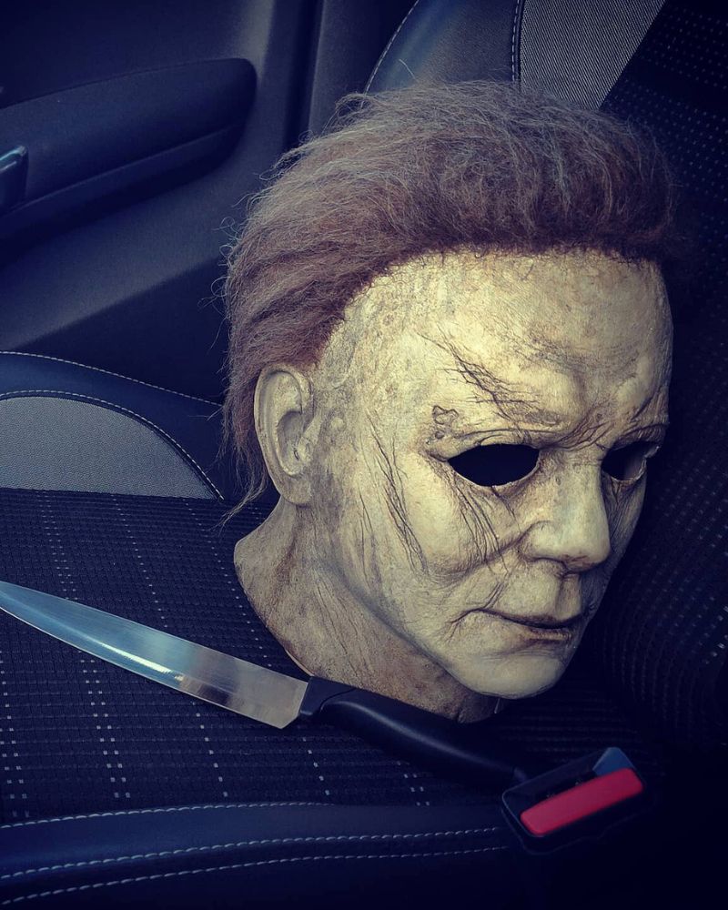 Michael Myers 2018 mask resting on a car seat beside a kitchen knife, captured before Halloween night — The Terror Lab.