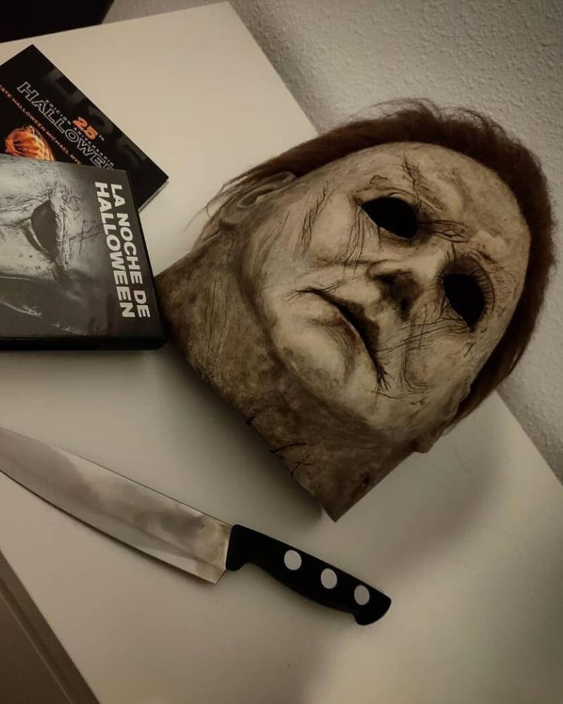 Michael Myers 2018 mask placed alongside a kitchen knife and classic horror films, ready for Halloween night. From The Terror Lab.