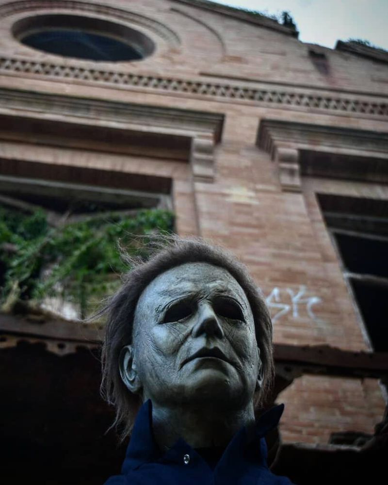 Michael Myers 2018 mask and costume captured in front of an abandoned building — a haunting presence returning just in time for Halloween. The Terror Lab.