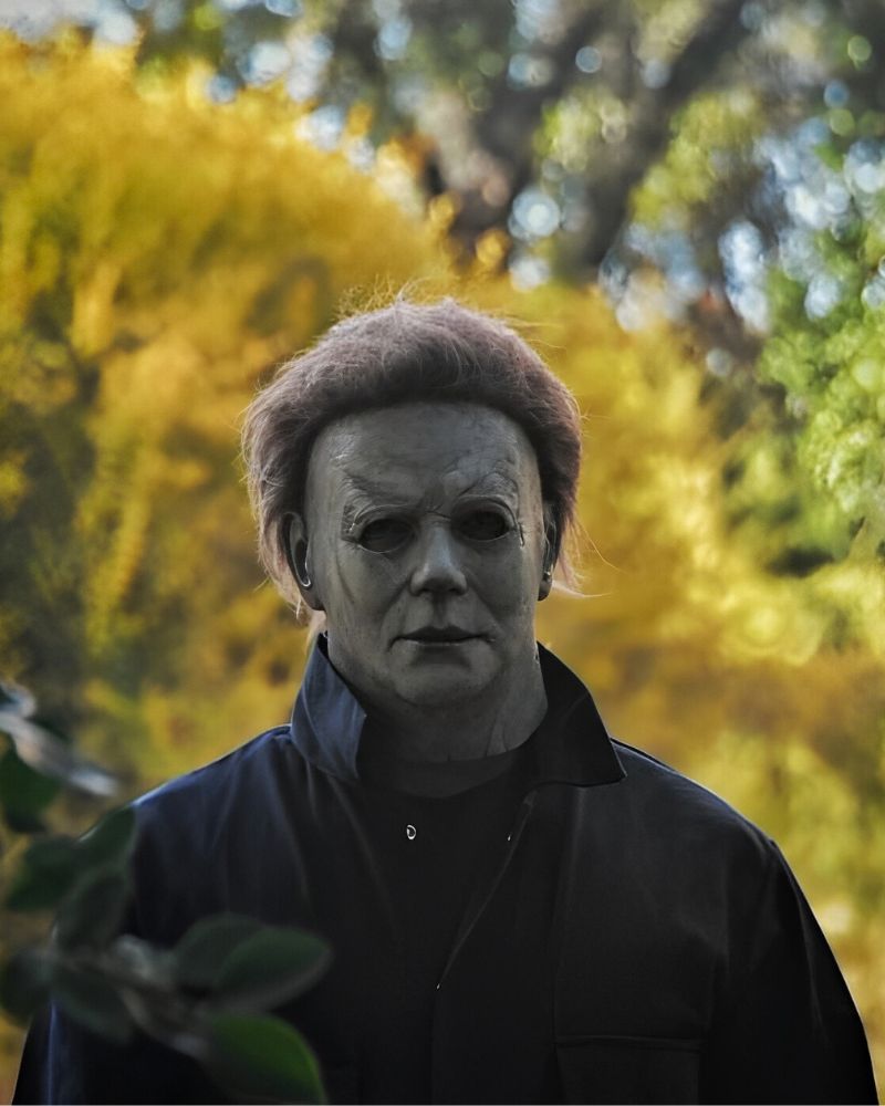 Michael Myers 2018 mask and costume standing in a forest during fall, captured before Halloween night from The Terror Lab.