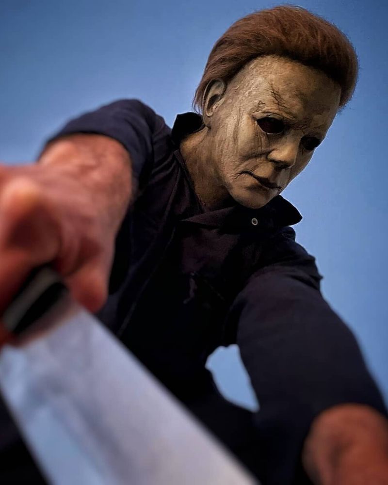 Michael Myers 2018 mask and costume standing in a forest during fall, captured before Halloween night from The Terror Lab.