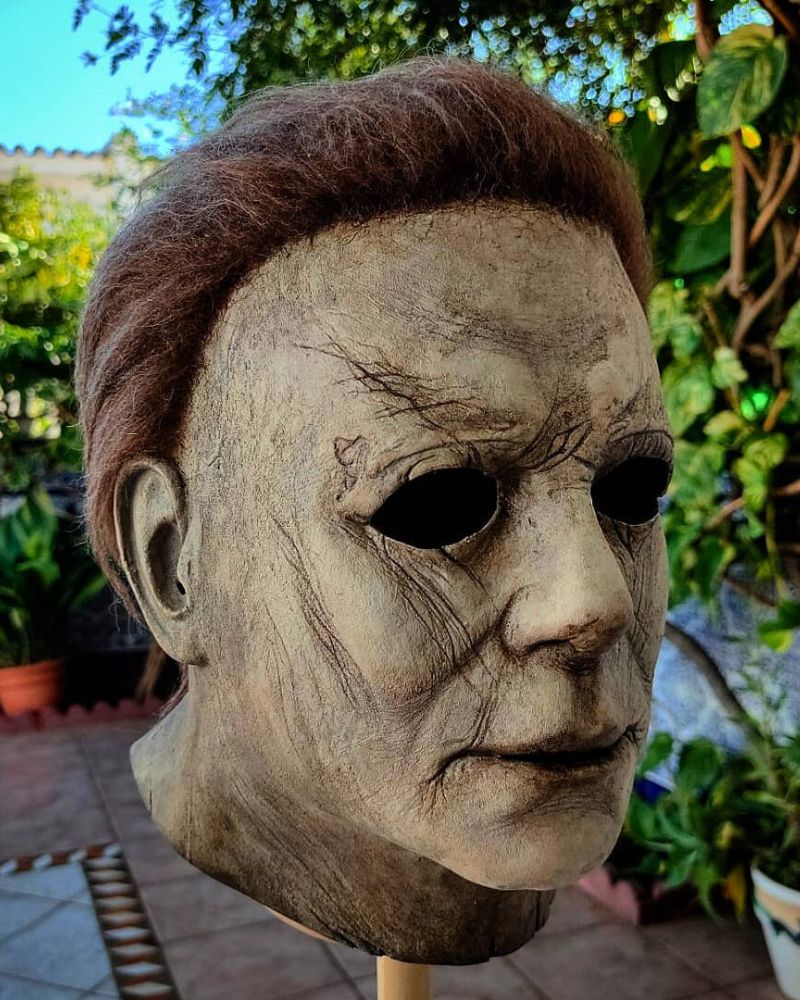 Close-up of the 2018 Michael Myers mask on display in a garden setting, showing texture and sculpted details — from The Terror Lab