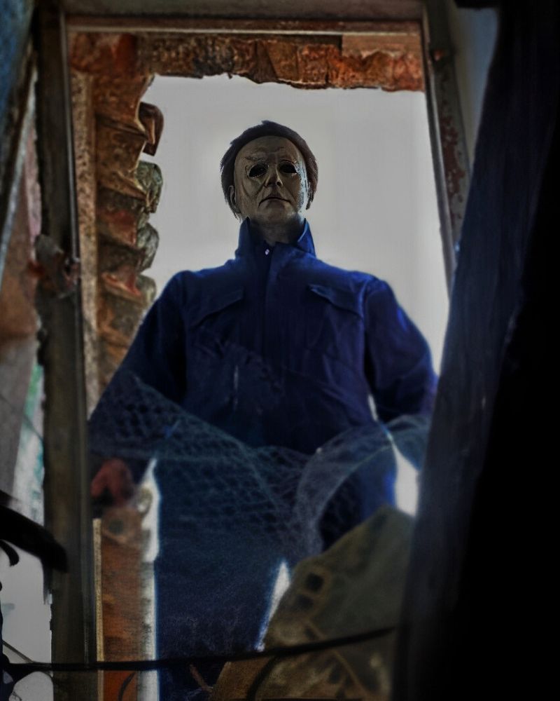 Customer wearing the 2018 Michael Myers mask and coveralls, standing in a broken doorway with a chilling stare — from The Terror Lab.