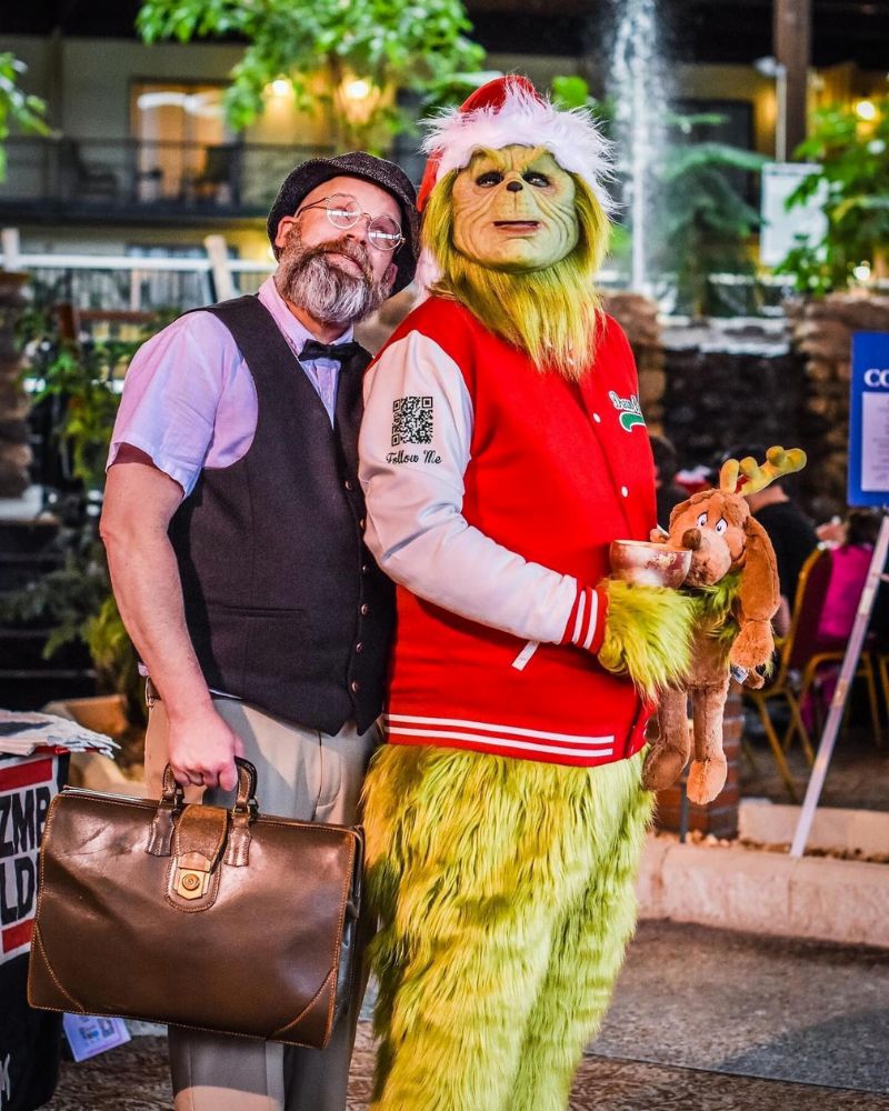 The Stealer of Christmas realistic mask and costume, seen at a festive event with Max the dog and a guest, originally crafted for Halloween appearances — The Terror Lab