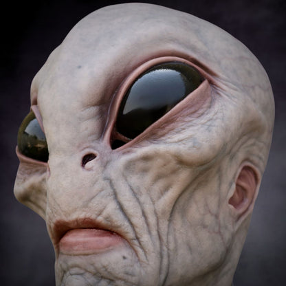 Close-up of an alien creature realistic mask with a dark background